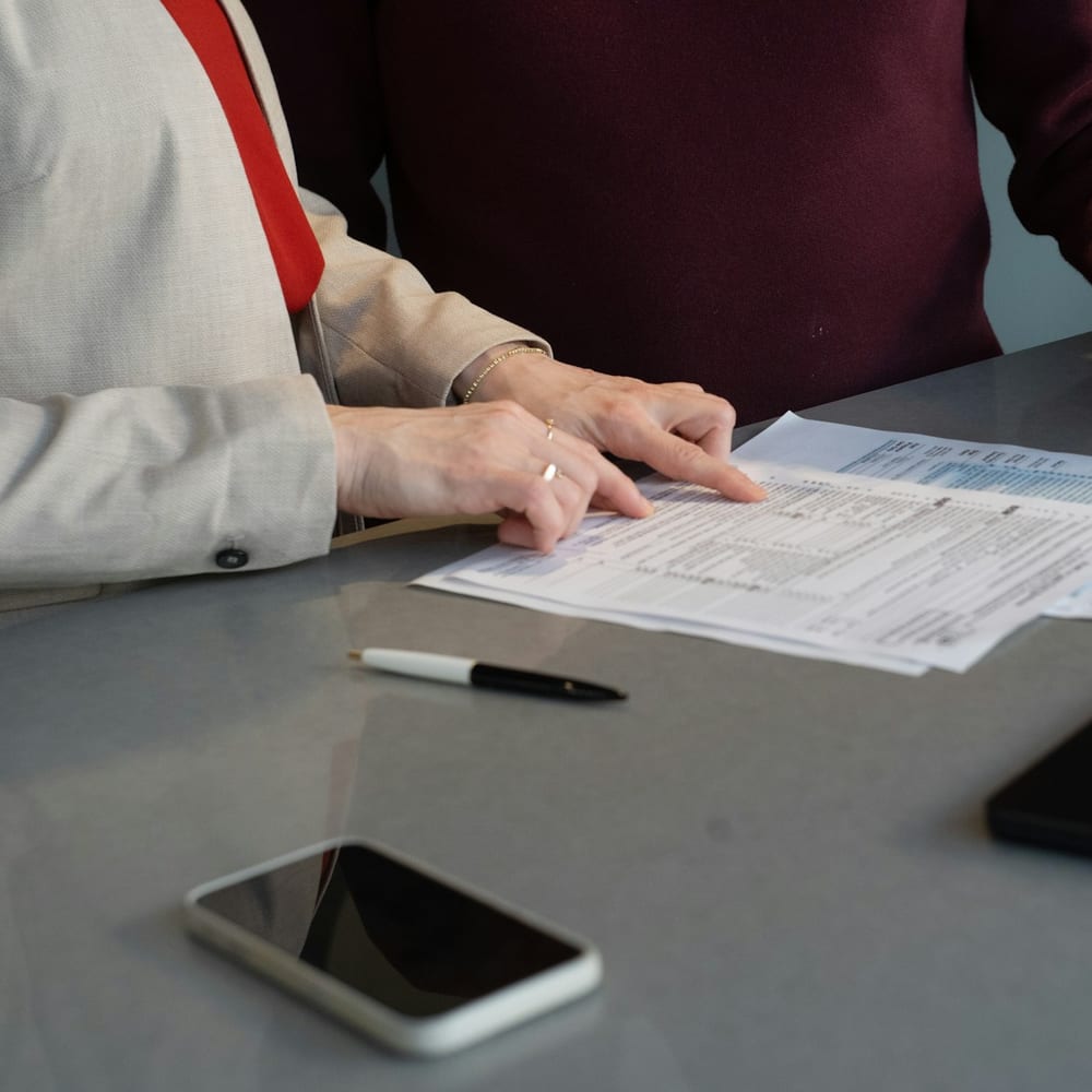 Two people reviewing mortgage paperwork at a table